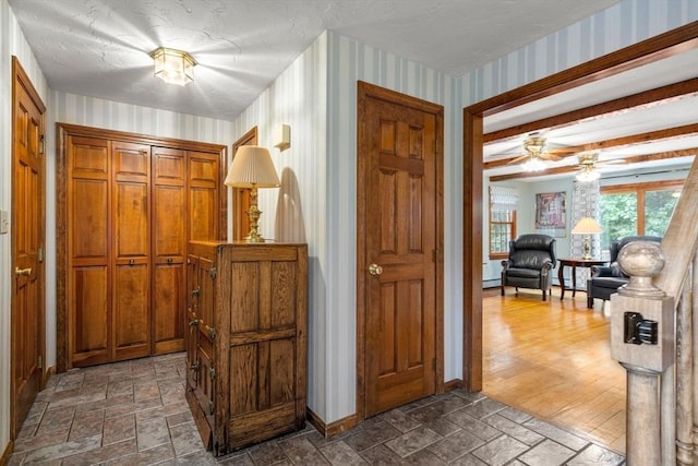 23 Lafayette Dr, Walpole, MA 02032 - foyer entrance featuring wallpapered walls, stone tile floors, a ceiling fan, and a baseboard heating unit