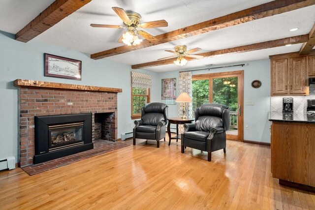 23 Lafayette Dr, Walpole, MA 02032 - living area with light wood finished floors, a baseboard radiator, beam ceiling, a brick fireplace, and a ceiling fan
