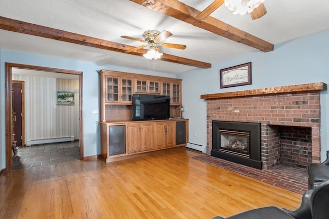 23 Lafayette Dr, Walpole, MA 02032 - living area with a ceiling fan, baseboard heating, beamed ceiling, and a brick fireplace