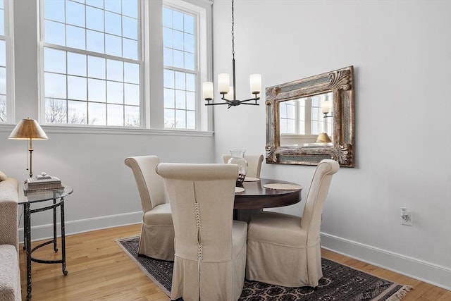 dining room with a chandelier and light hardwood / wood-style flooring