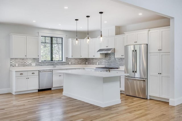 92 Whiffletree Ave, Brewster, MA 02631 - kitchen featuring stainless steel appliances, under cabinet range hood, light countertops, white cabinets, and tasteful backsplash