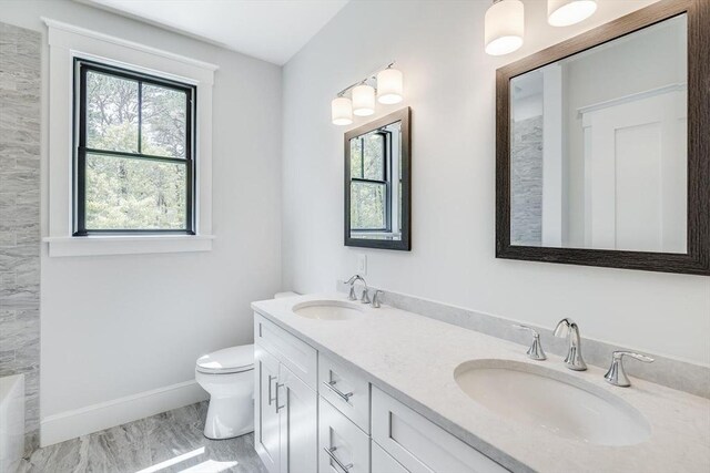 92 Whiffletree Ave, Brewster, MA 02631 - full bathroom with marble look tile flooring, healthy amount of natural light, toilet, and double vanity