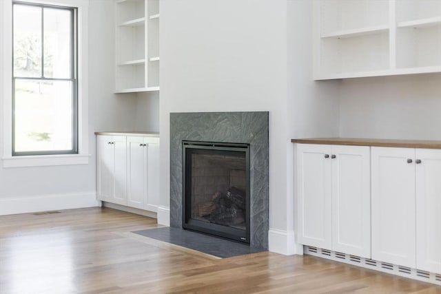92 Whiffletree Ave, Brewster, MA 02631 - unfurnished living room featuring a fireplace, light wood finished floors, baseboard heating, and plenty of natural light
