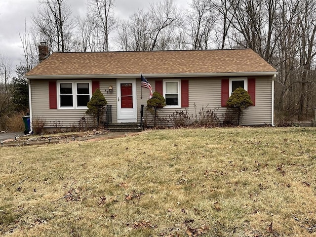 single story home featuring entry steps, roof with shingles, a chimney, and a front yard