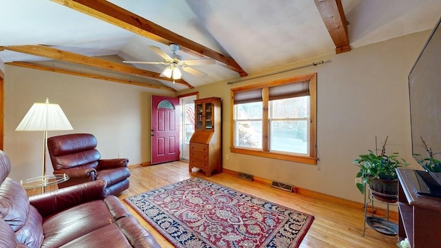 living area with vaulted ceiling with beams, light wood finished floors, baseboards, and visible vents