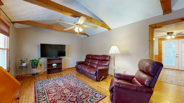 living area featuring ceiling fan, french doors, vaulted ceiling with beams, and wood finished floors