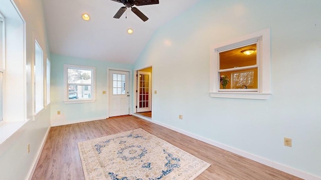 spare room with ceiling fan, high vaulted ceiling, recessed lighting, wood finished floors, and baseboards