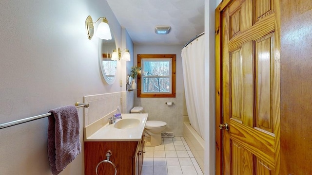 bathroom featuring tile walls, shower / bathtub combination with curtain, toilet, vanity, and tile patterned floors