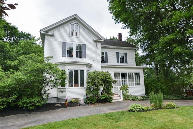 37 Pemberton Rd, Wayland, MA 01778 - view of front facade with a chimney and a front yard
