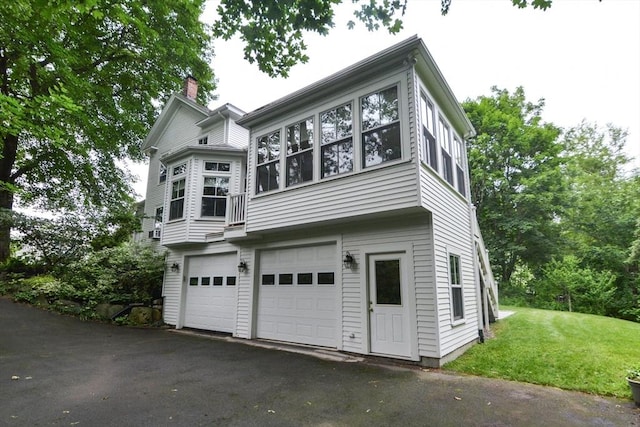 37 Pemberton Rd, Wayland, MA 01778 - view of side of home with an attached garage, a chimney, driveway, and a yard