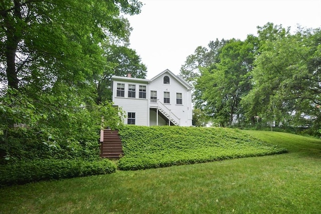 37 Pemberton Rd, Wayland, MA 01778 - rear view of property with stairs, a chimney, and a lawn