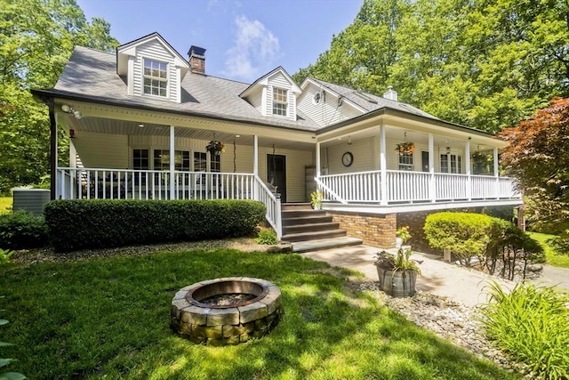 60 Daniel Shays Hwy, Pelham, MA 01002 - view of front of property with covered porch, a chimney, an outdoor fire pit, and a front lawn