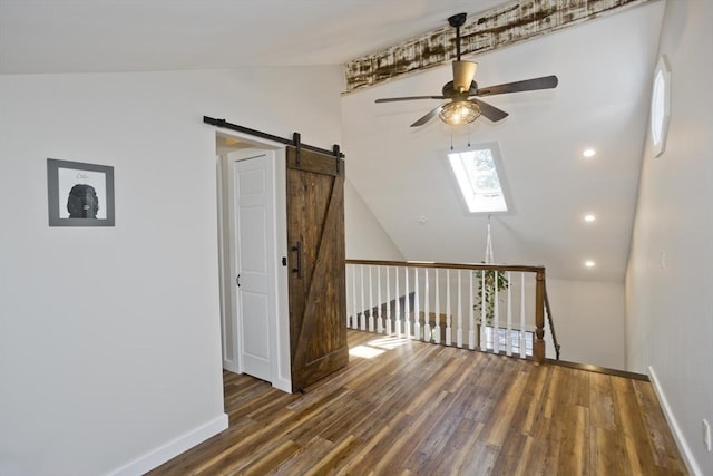 60 Daniel Shays Hwy, Pelham, MA 01002 - empty room with lofted ceiling, a ceiling fan, wood finished floors, a barn door, and a skylight