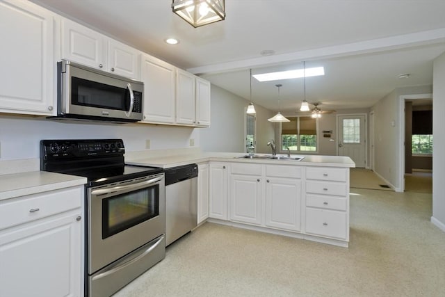 60 Daniel Shays Hwy, Pelham, MA 01002 - kitchen featuring appliances with stainless steel finishes, a peninsula, white cabinetry, light countertops, and hanging light fixtures