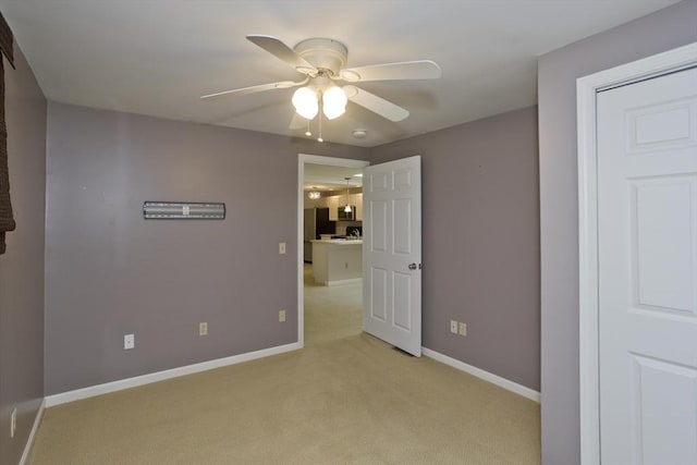 60 Daniel Shays Hwy, Pelham, MA 01002 - unfurnished bedroom featuring light colored carpet, a ceiling fan, and freestanding refrigerator