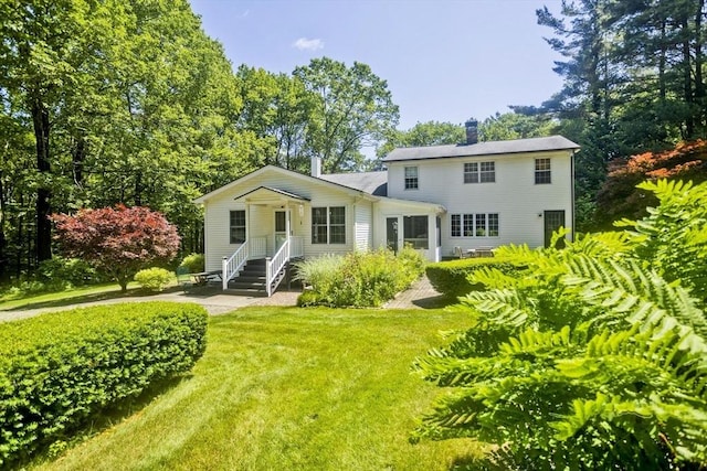 60 Daniel Shays Hwy, Pelham, MA 01002 - rear view of house with a chimney and a lawn