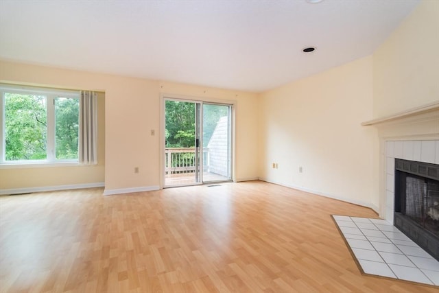 17 Harbor Hl Unit 17, Bourne, MA 02532 - unfurnished living room with a tile fireplace and light wood finished floors