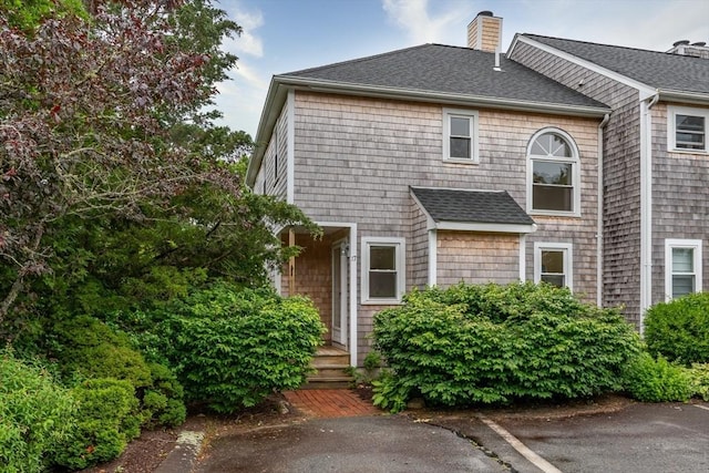 17 Harbor Hl Unit 17, Bourne, MA 02532 - view of front of house featuring a chimney and roof with shingles