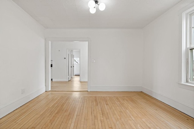 unfurnished room with light wood-style flooring and baseboards