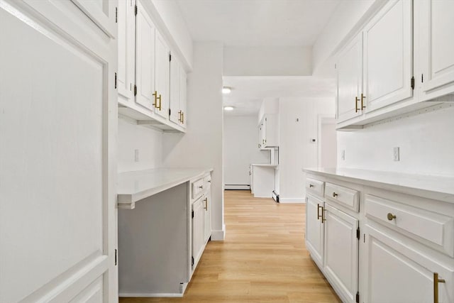 bar with light wood-style floors and a baseboard radiator