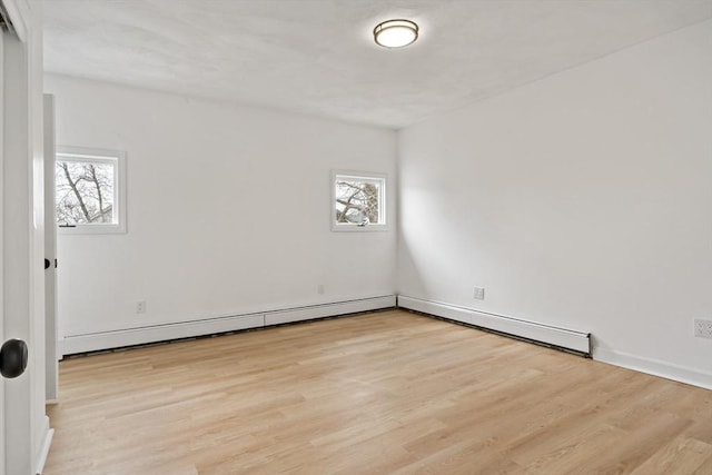 empty room with a wealth of natural light and wood finished floors