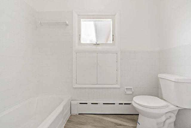 full bath with wainscoting, toilet, a baseboard radiator, wood finished floors, and tile walls