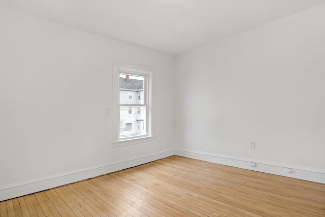 empty room featuring light wood-style floors and baseboards