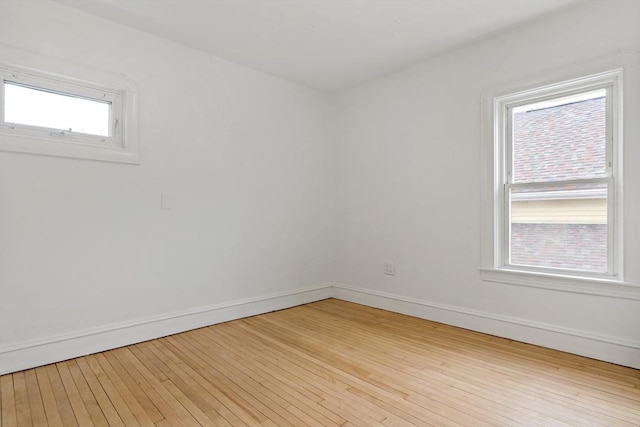 empty room with light wood-style flooring and baseboards