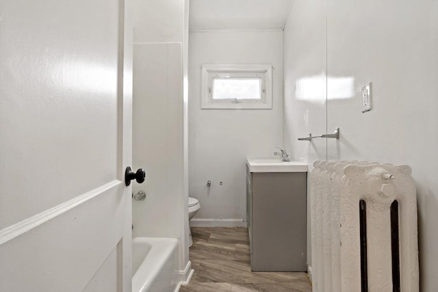 bathroom with vanity, toilet, and wood finished floors