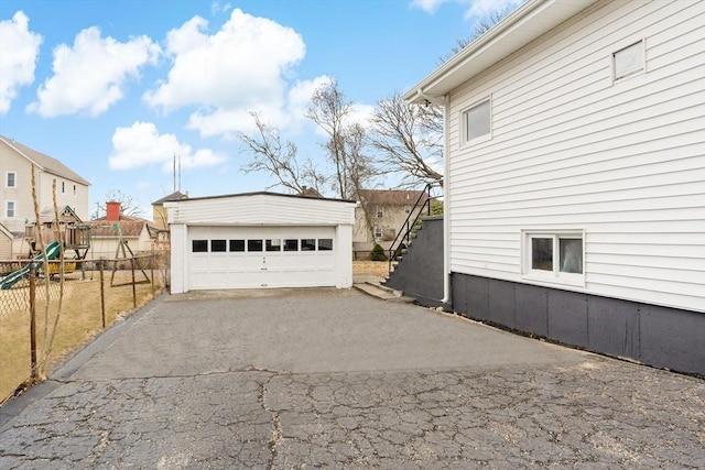 detached garage featuring fence