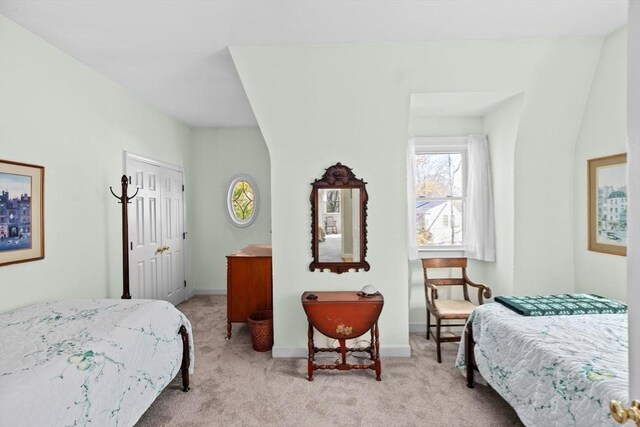 bedroom featuring baseboards and light colored carpet