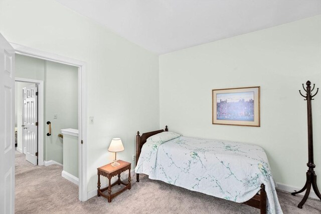 bedroom with carpet floors and baseboards
