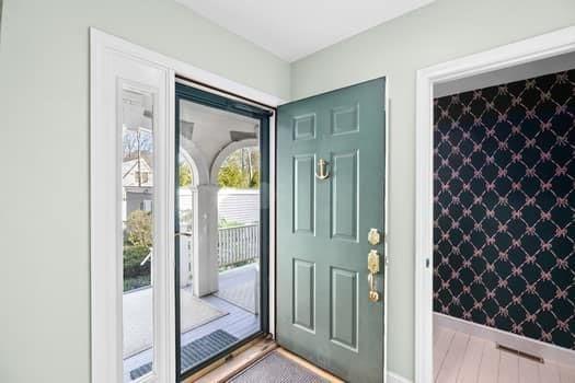 entryway featuring wallpapered walls