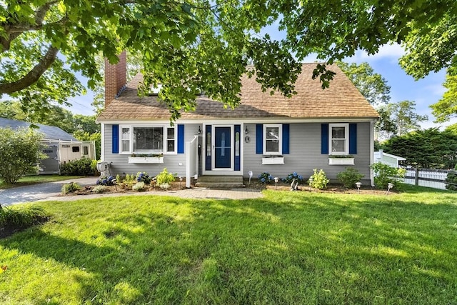 28 Chestnut St, Falmouth, MA 02536 - cape cod house with a chimney and roof with shingles