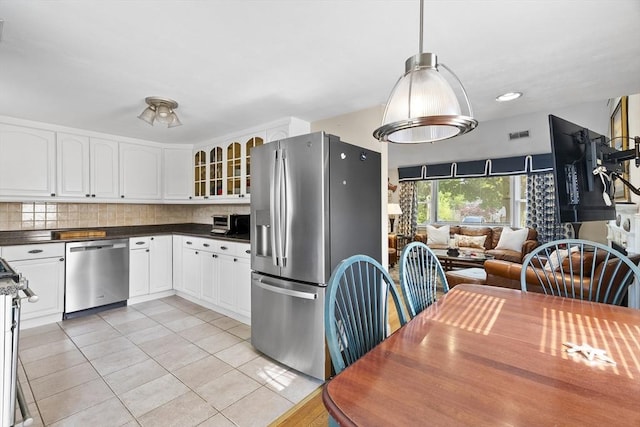28 Chestnut St, Falmouth, MA 02536 - kitchen featuring appliances with stainless steel finishes, light tile patterned flooring, open floor plan, glass insert cabinets, and white cabinetry