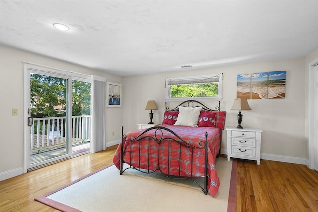 28 Chestnut St, Falmouth, MA 02536 - bedroom with access to outside, wood finished floors, and multiple windows