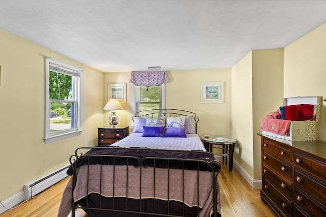 28 Chestnut St, Falmouth, MA 02536 - bedroom with light wood-style floors and a baseboard heating unit