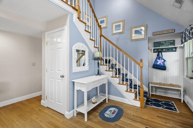28 Chestnut St, Falmouth, MA 02536 - staircase featuring wood finished floors and vaulted ceiling