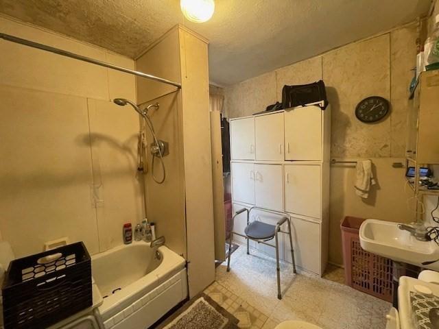 268-270 Providence Rd, Grafton, MA 01560 - bathroom with shower / washtub combination, a sink, tile patterned floors, and a textured ceiling