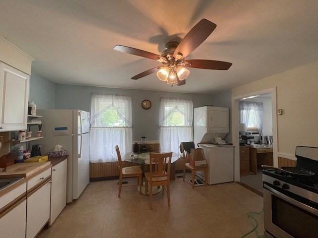 268-270 Providence Rd, Grafton, MA 01560 - kitchen with gas range, white cabinetry, ceiling fan, and freestanding refrigerator