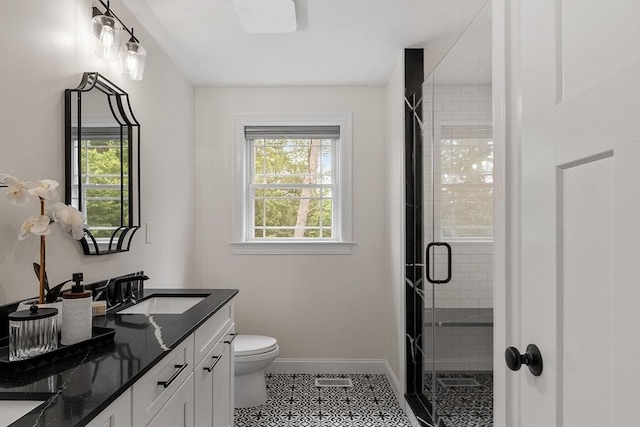 32 Gilman Rd, Billerica, MA 01862 - full bathroom featuring double vanity, a shower stall, baseboards, toilet, and tile patterned flooring