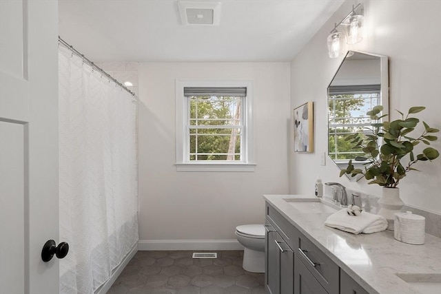 32 Gilman Rd, Billerica, MA 01862 - full bathroom featuring toilet, double vanity, tile patterned floors, curtained shower, and baseboards