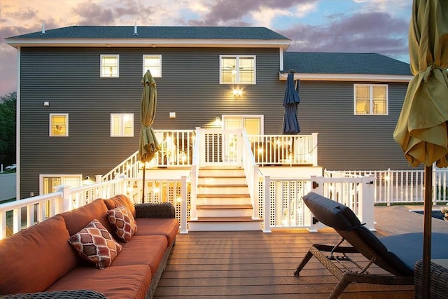 32 Gilman Rd, Billerica, MA 01862 - back of property at dusk with a deck, stairway, and an outdoor hangout area