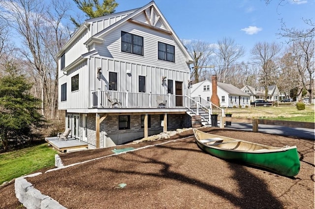 exterior space with stone siding, board and batten siding, and a deck