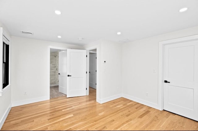 unfurnished bedroom featuring visible vents, light wood-style flooring, and recessed lighting