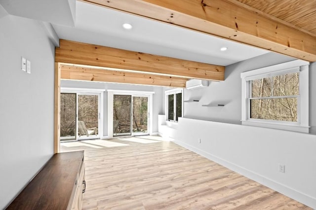 interior space with recessed lighting, an AC wall unit, baseboards, beamed ceiling, and wood finished floors