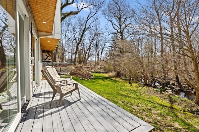 wooden deck featuring a yard