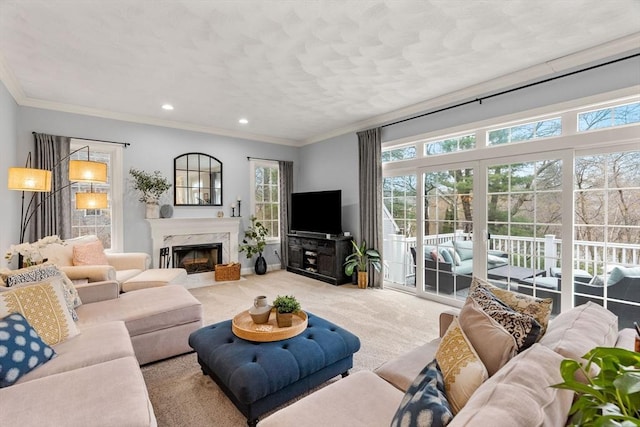 carpeted living room with recessed lighting, crown molding, and a fireplace