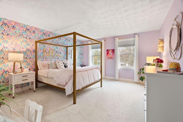bedroom with baseboards, light carpet, and a textured ceiling