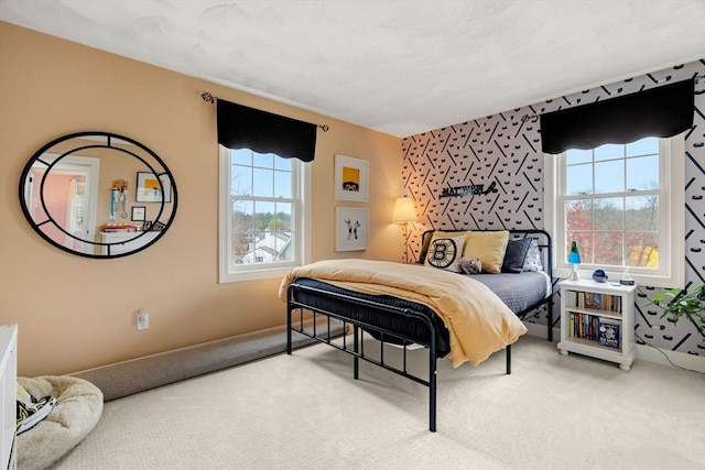 bedroom with multiple windows and carpet
